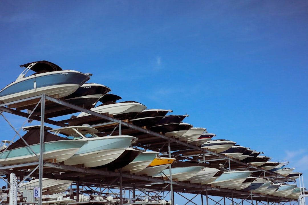 A well-organized boat storage facility with various boats on trailers and in storage units, showcasing different types of boat storage options.
