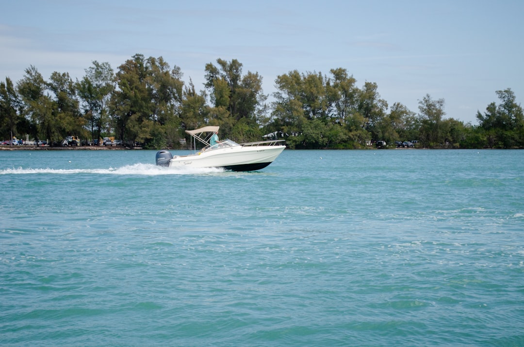 A center console boat navigating through calm waters, showcasing its central helm and 360-degree visibility.