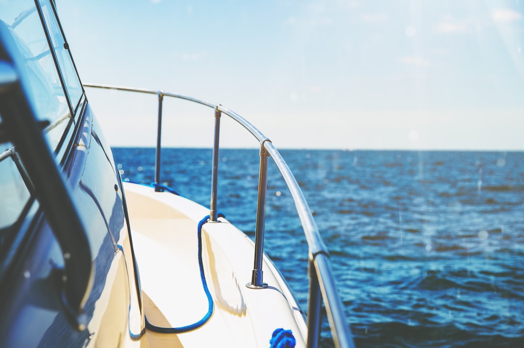 A serene image of a boat on calm waters with safety equipment visible on board, such as life jackets and a first aid kit.