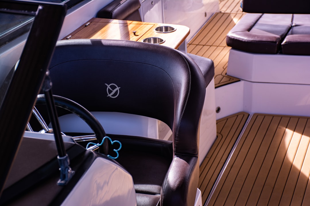 A cozy and inviting seating area on a boat, featuring plush cushions and a scenic view of the water.
