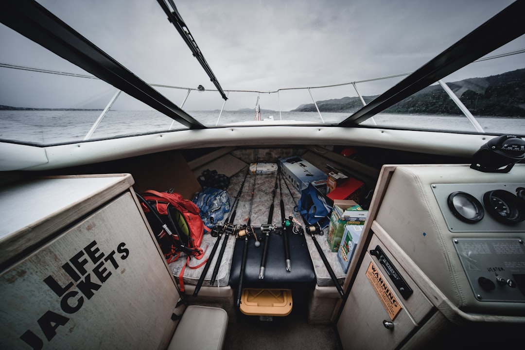 A neatly organized boat deck with various gear stored in designated areas, showcasing a clean and functional space for fishing and entertaining.