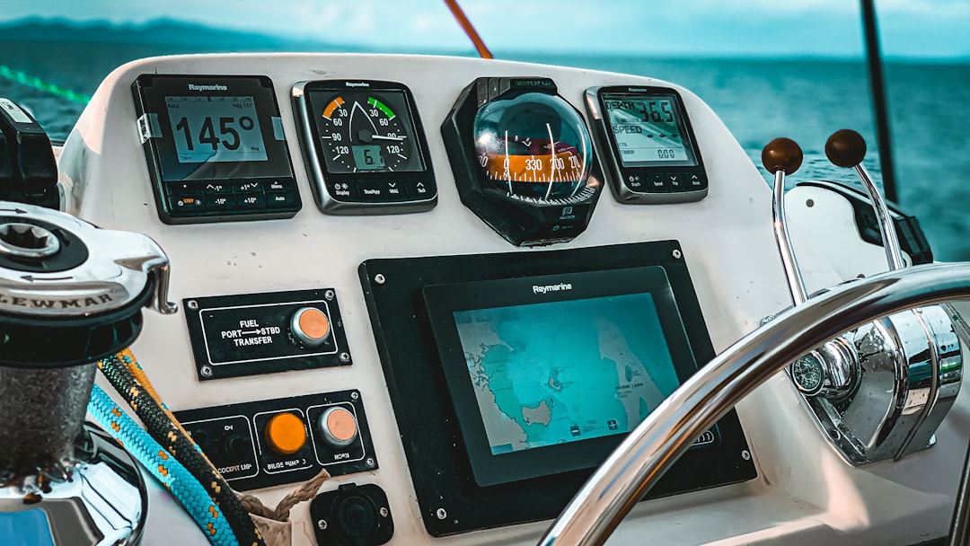 A close-up view of marine electronics equipment on a boat, including navigation screens, sonar displays, and communication devices.