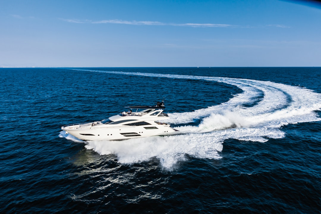 A variety of new boats lined up at a marina, showcasing different styles and sizes for potential buyers.